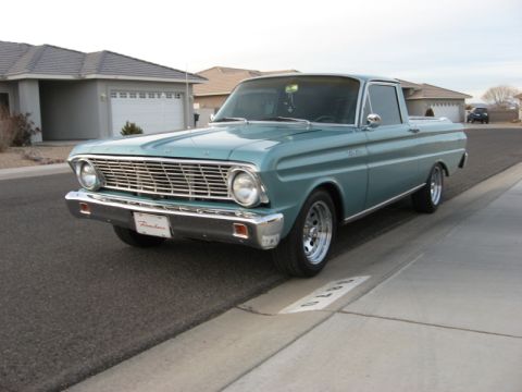 1972 Ford Ranchero - This teal Ford Ranchero pickup truck is parked on a residential street, showing its front and side profile.