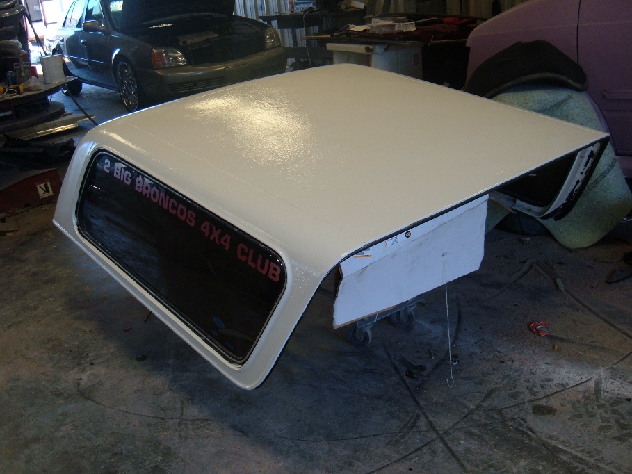 White Ford Bronco hardtop with red text reading '2 BIG BRONCOS 4X4 CLUB' on the window