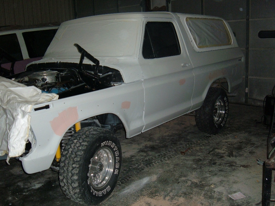 White 1978 Ford Bronco in primer, hood open, ready for paint