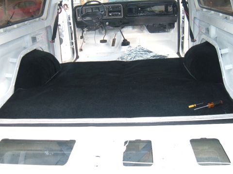 1978 Ford Bronco - 1978 Ford Bronco interior showing new carpet installation in the cargo area and front cabin.