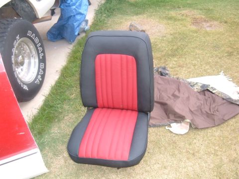 1978 Ford Bronco - Car seat with red and black upholstery, part of a vehicle restoration project.