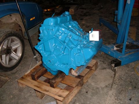 1978 Ford Bronco - A freshly painted blue engine sits on a wooden pallet, ready for installation.