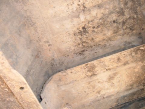 1978 Ford Bronco - Undercarriage view showing floor coating and structural components.