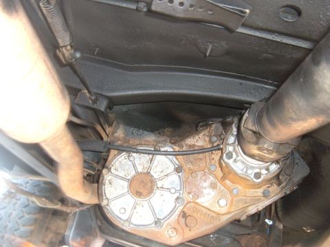 1978 Ford Bronco - Close-up of a vehicle's transfer case and driveshaft, showing part numbers.