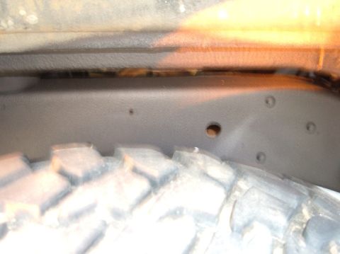 1978 Ford Bronco - Undercarriage view showing the frame and a portion of the tire.