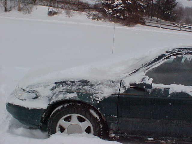 Partially cleaned to show how high snow was on the car.