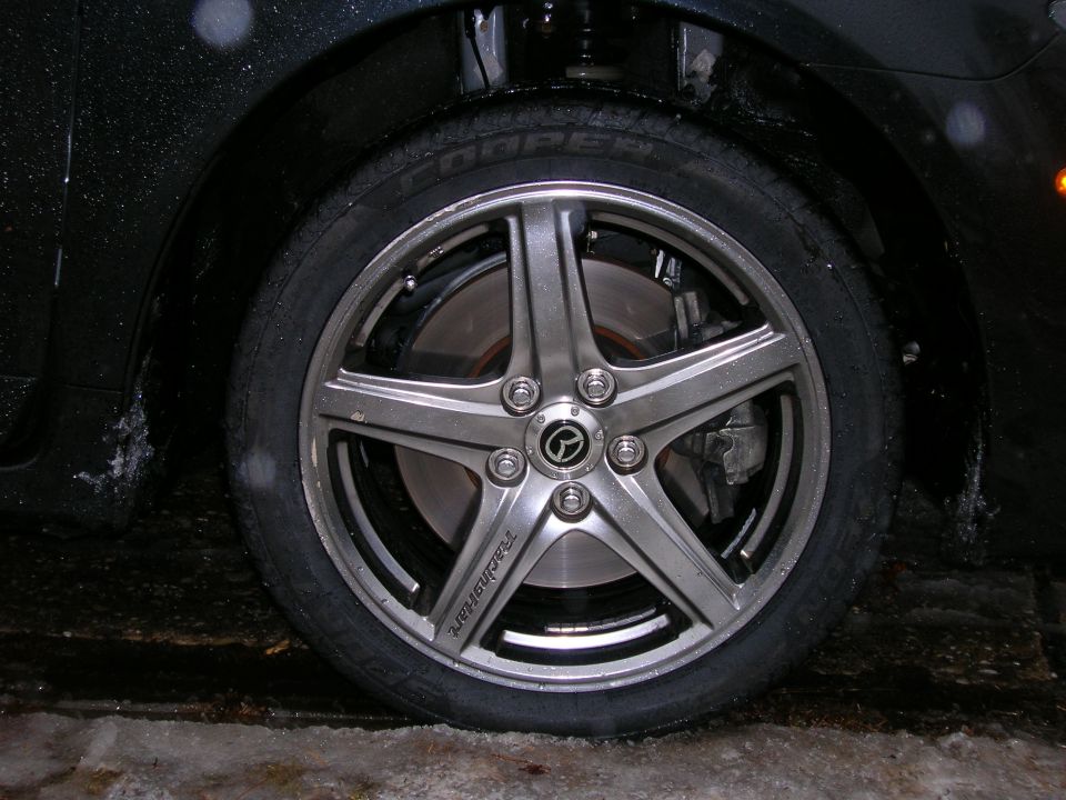Close-up of a five-spoke alloy wheel with a Mazda logo center cap and 'Techstar' text on one spoke
