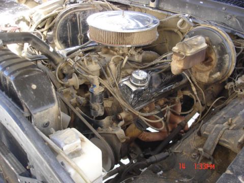 1979 Ford Bronco - Close-up view of a vehicle's engine compartment, showing various mechanical parts and hoses.