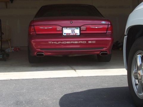 1996 Mercury Grand Marquis - Rear view of a red 1995 Ford Thunderbird SC, showing its dual exhaust pipes and SC badging.