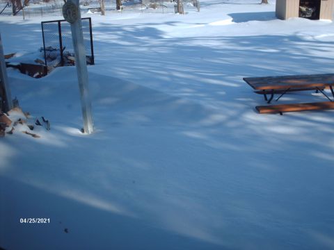 1995 Ford Probe - A snow-covered yard features a picnic table and a wooden structure, with shadows cast across the snow. The date stamp indicates April 25, 2…