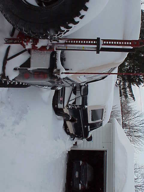 1993 Ford Bronco - A 1993 Ford Bronco is stuck in deep snow, with a Hi-Lift jack ready for use.
