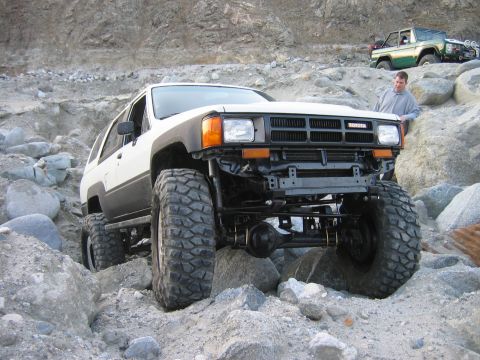 1985 Toyota 4Runner - A modified 1985 Toyota 4Runner navigates a rocky trail, with another vehicle visible in the distance.