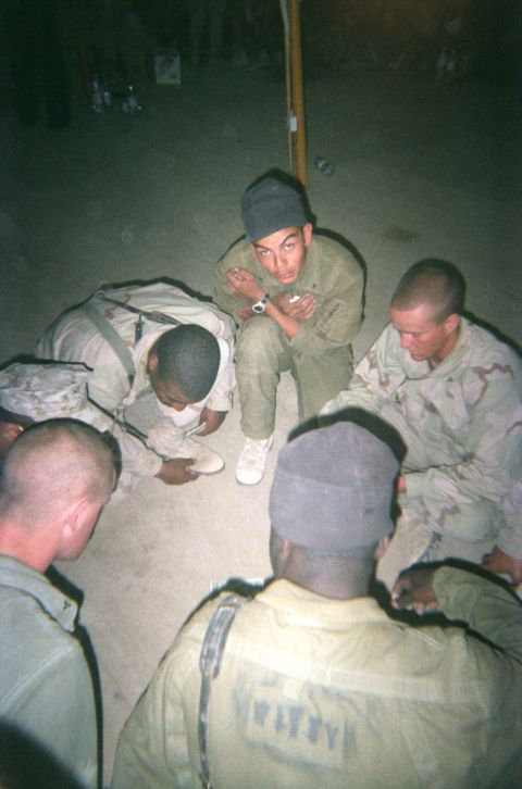 1979 Chevrolet Blazer - A group of soldiers are gathered together in a circle on the ground.