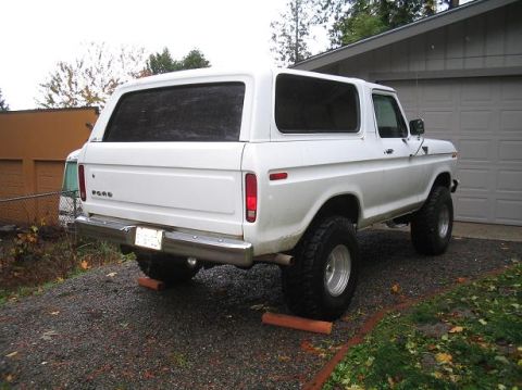 1979 Ford Bronco - This white Ford Bronco is parked in a driveway with a garage in the background.