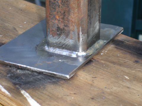 1989 Ford Bronco - A close-up view of a welded metal bracket on a wooden surface, with a Supermotors.net logo visible.