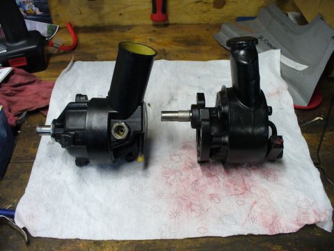 1978 Ford Bronco - Two power steering pumps are laid out on a white cloth, likely for repair or replacement.