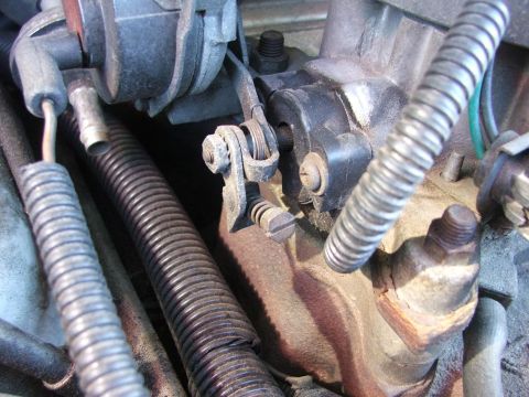 1985 Ford Crown Victoria LTD - Carburetor linkage detail, showing springs and mechanical connections.