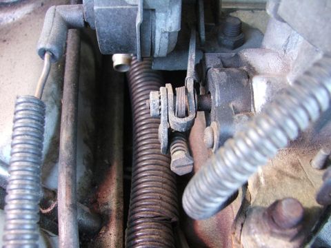 1985 Ford Crown Victoria LTD - Close-up view of the throttle linkage and associated wiring harness components.