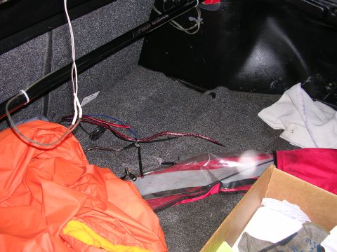 1996 Ford Probe - Interior view of a car trunk containing various items and loose wiring.