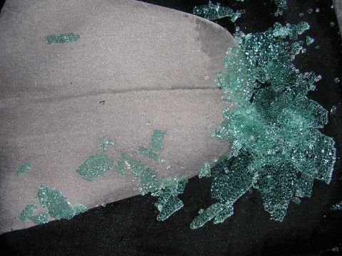 1996 Ford Probe - Shattered glass litters the interior of a vehicle, indicating a break-in or accident.