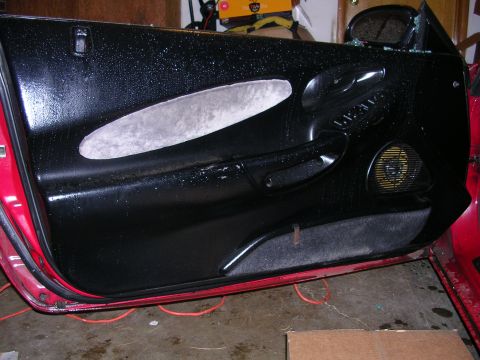 1996 Ford Probe - Interior view of a car door panel, showing the speaker and door handle assembly.