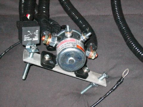 1991 Ford Bronco - Close-up view of a vehicle's starter solenoid and relay assembly, with thick black wiring harnesses.