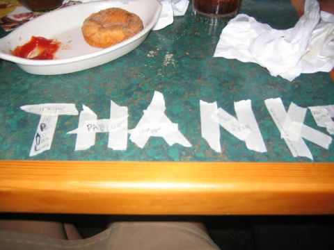 1979 Ford Bronco - A table displays a donut, ketchup, and tape spelling out 'THANK YOU' with names.