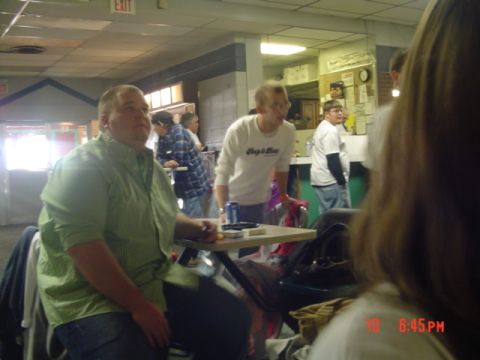 1995 Ford Probe - Several individuals are seen inside a bowling alley, with some conversing and others looking around the room.
