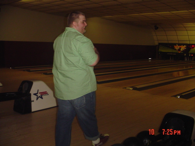 Bowling alley scene with a man standing and bowling lanes