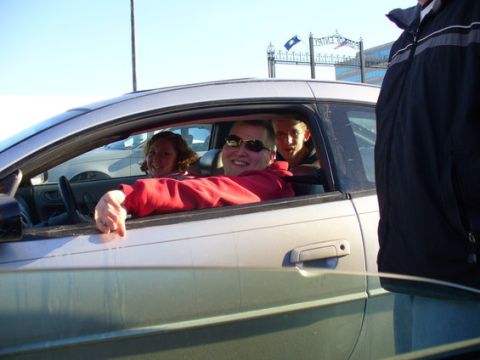 1995 Ford Probe - Three people are inside a silver car on a sunny day, with one person leaning out the window.