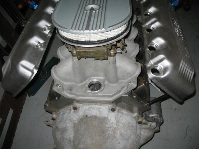 Ford V8 engine block with intake manifold, carburetor, air cleaner, and aluminum valve covers