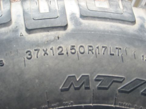 1966 Ford Bronco - This image shows a close-up of a tire, detailing its size and brand markings.