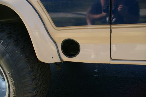 1986 Ford Bronco - Close up of exhaust exit, I lined the hole with door jam weatherstripping