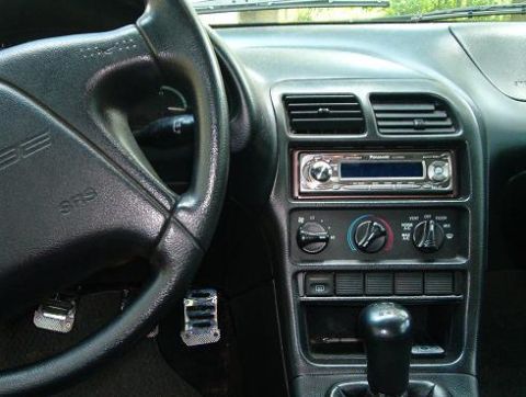 1995 Ford Probe - The interior of a 1995 Ford Probe is visible, focusing on the driver's side dashboard and controls.