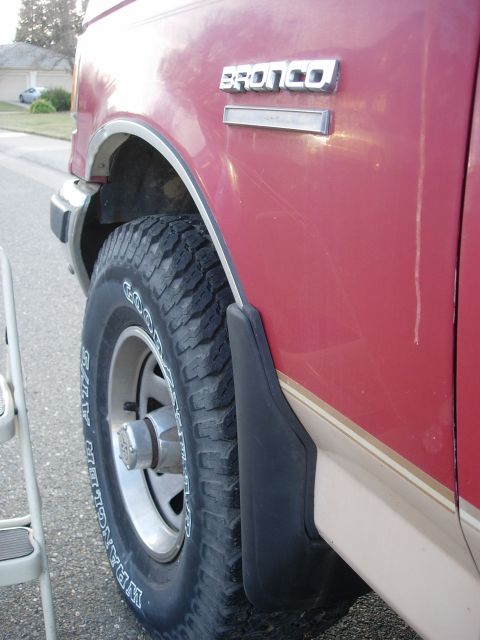 1990 Ford Bronco - Close-up of a 1990 Ford Bronco's fender and wheel, with the model name visible.