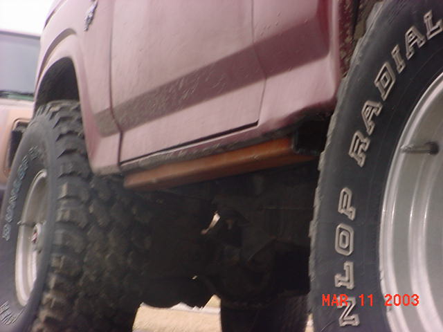 one more pic of the rock sliders installed from the back by the drivers sidfe tire. I got this Idea from a post at 2 big broncos site here is a link to the write up. http://www.2bigbroncos.com/technical/andy_rock_guards/index.html