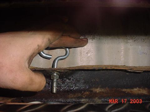 1980 Ford Bronco - here is a pic of the tank raised as high as I could get it. my finger represents where the old tank and the rear cross member meet up