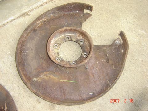 1993 Ford Bronco - This is a rusted brake dust shield, likely for a truck or SUV.