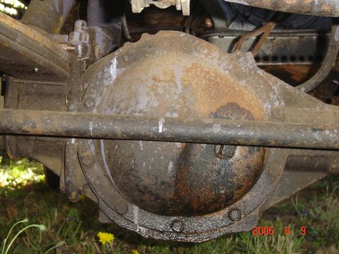 1993 Ford Bronco - Close-up of a vehicle's rear axle differential, showing suspension components and signs of wear.