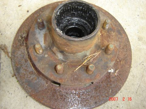 1993 Ford Bronco - This is a rusted wheel hub assembly with visible grease inside the spindle.