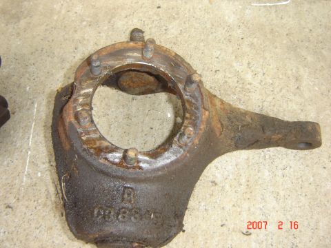 1993 Ford Bronco - Close-up of a heavily rusted steering knuckle, likely a replacement part.