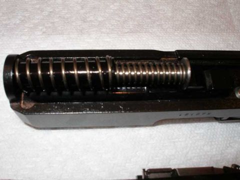 1998 Ford Crown Victoria - Close-up of a gun's slide interior with the recoil spring assembly visible.