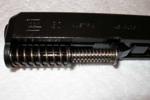 1998 Ford Crown Victoria - The recoil spring assembly is visible on this disassembled firearm slide.