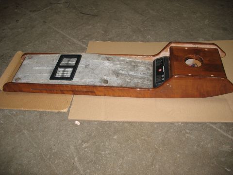 1995 Ford C-350 (Centurion Conversions) - Wooden overhead console with a black vent and a black control panel, possibly from a van or RV.