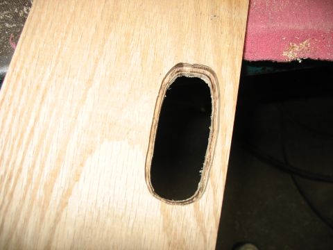 1995 Ford C-350 (Centurion Conversions) - A cutout is visible in a wood panel, with sawdust on an adjacent pink surface.
