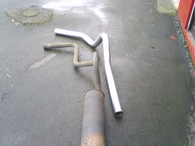 stock exhaust next to the new tailpipe