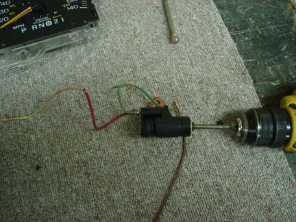 1992 Ford Crown Victoria - A car's dashboard gauge and wiring are shown next to a component being worked on with a drill.