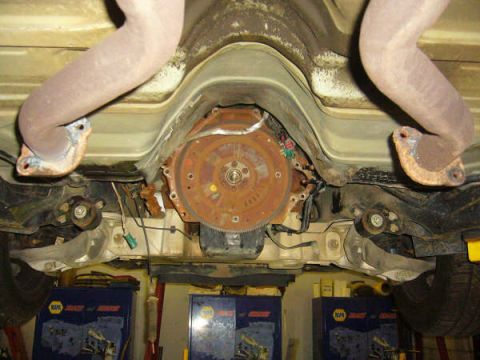 1996 Mercury Grand Marquis - Underside view of a vehicle's transmission and exhaust components.