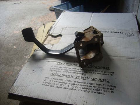 1996 Mercury Grand Marquis - A rusty clutch pedal assembly is shown resting on a cardboard box with tire size information.