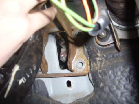 1996 Mercury Grand Marquis - Close-up view of wiring and mechanical components inside a vehicle's interior.